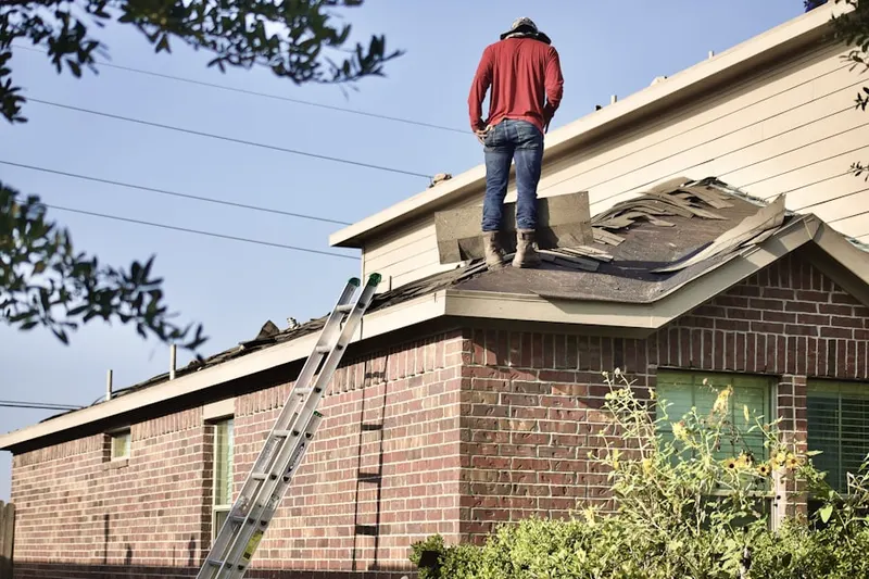 Professional roofer working on a residential roof in Old Mill Court